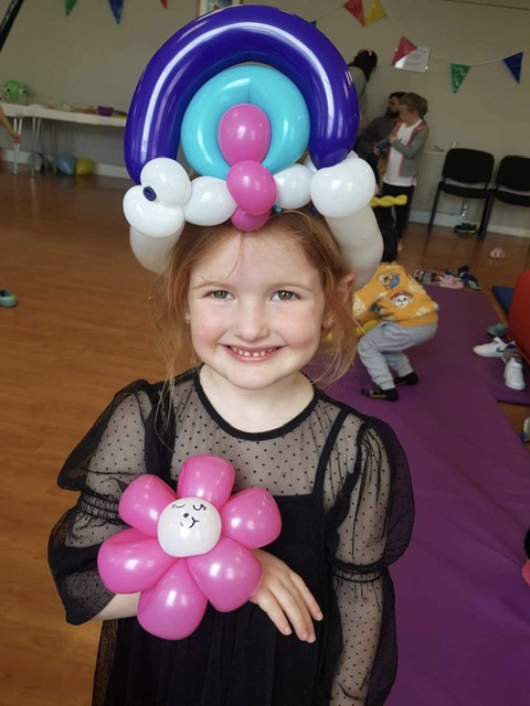 girl wearing a balloon hat at a party in Telford