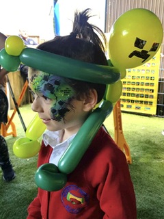 boy with a minecraft balloon hat and minecraft face paint in Telford