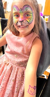 girl with face painted like a rainbow leopard in Albrighton