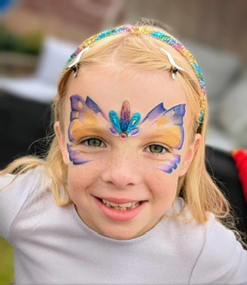 Girl with butterfly face painting in Shifnal