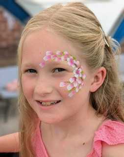 girl with flowers painted on her face in Shifnal