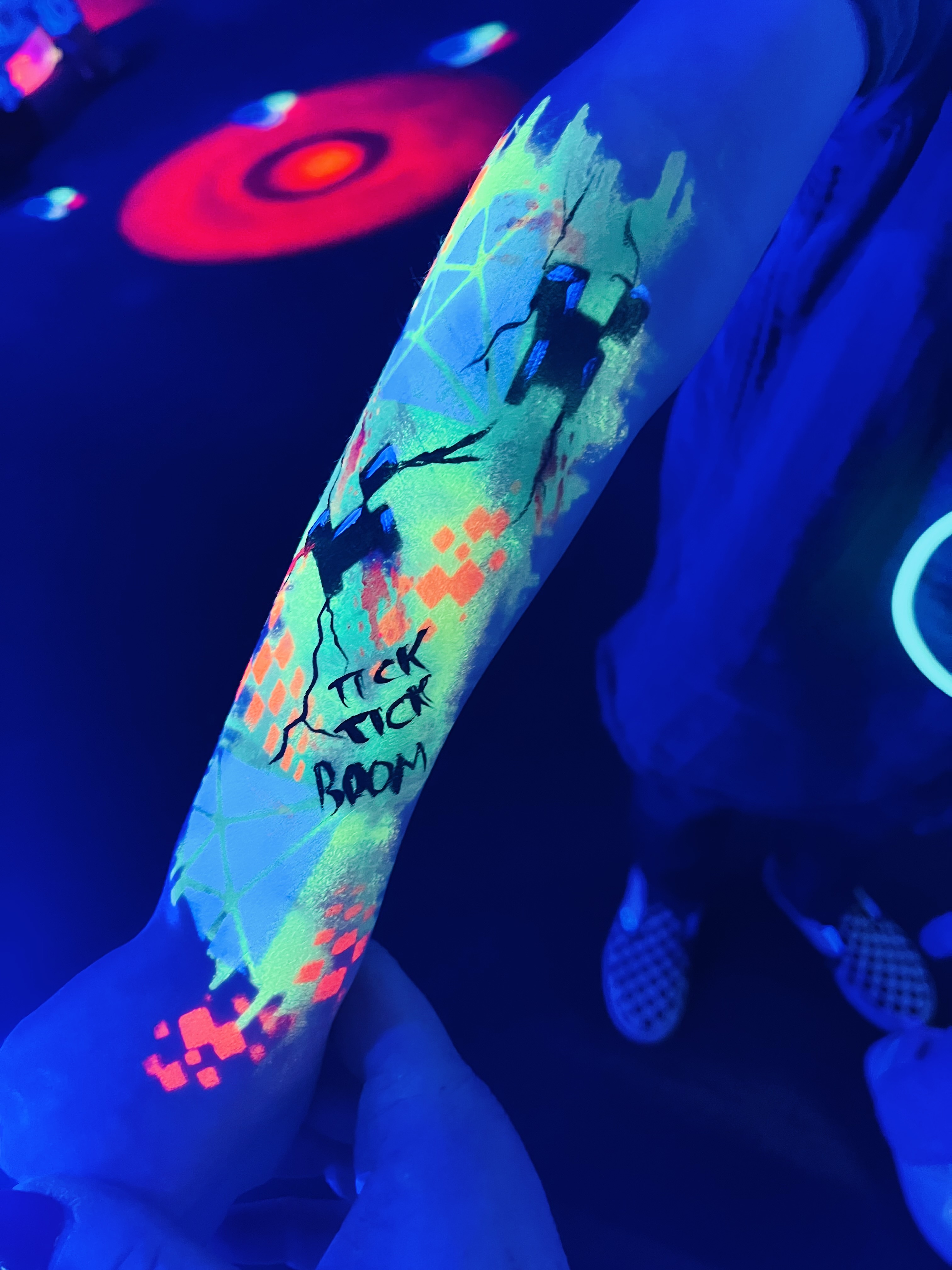 glowing uv minecraft painted tattoo sleeve on a childs arm 