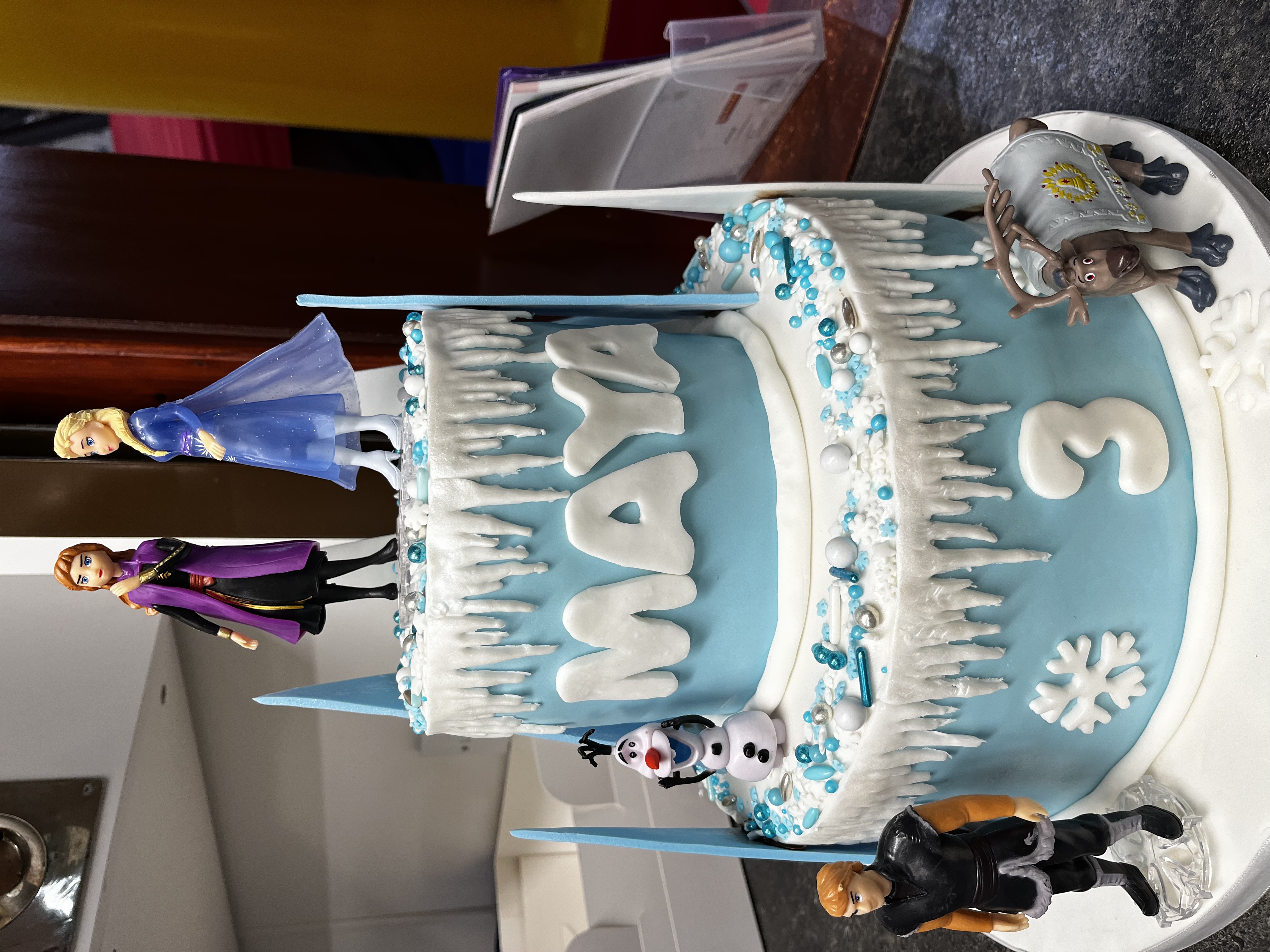 Frozen themed birthday cake with characters on top