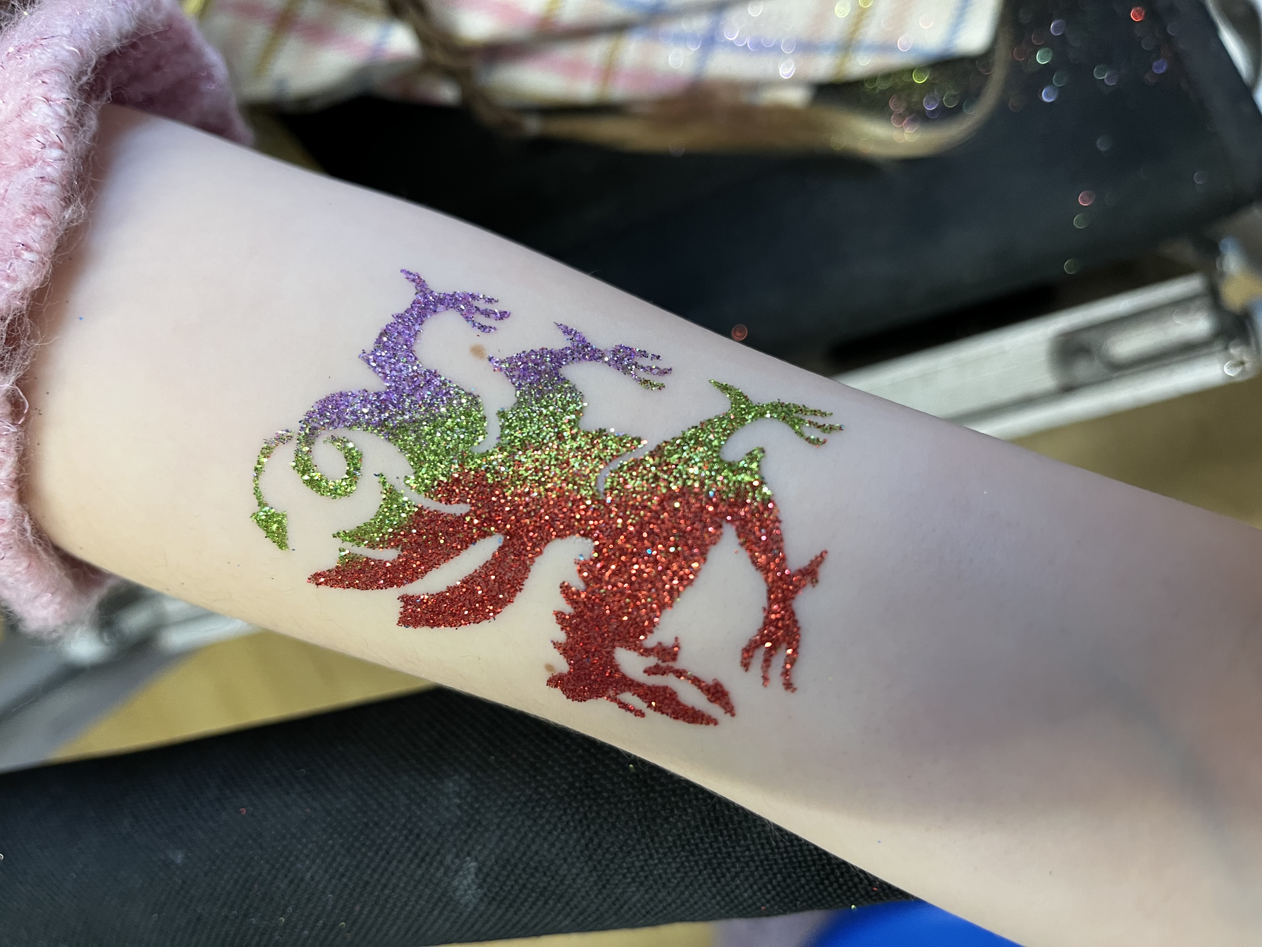 Welsh dragon glittertattoo on girls arm in telford