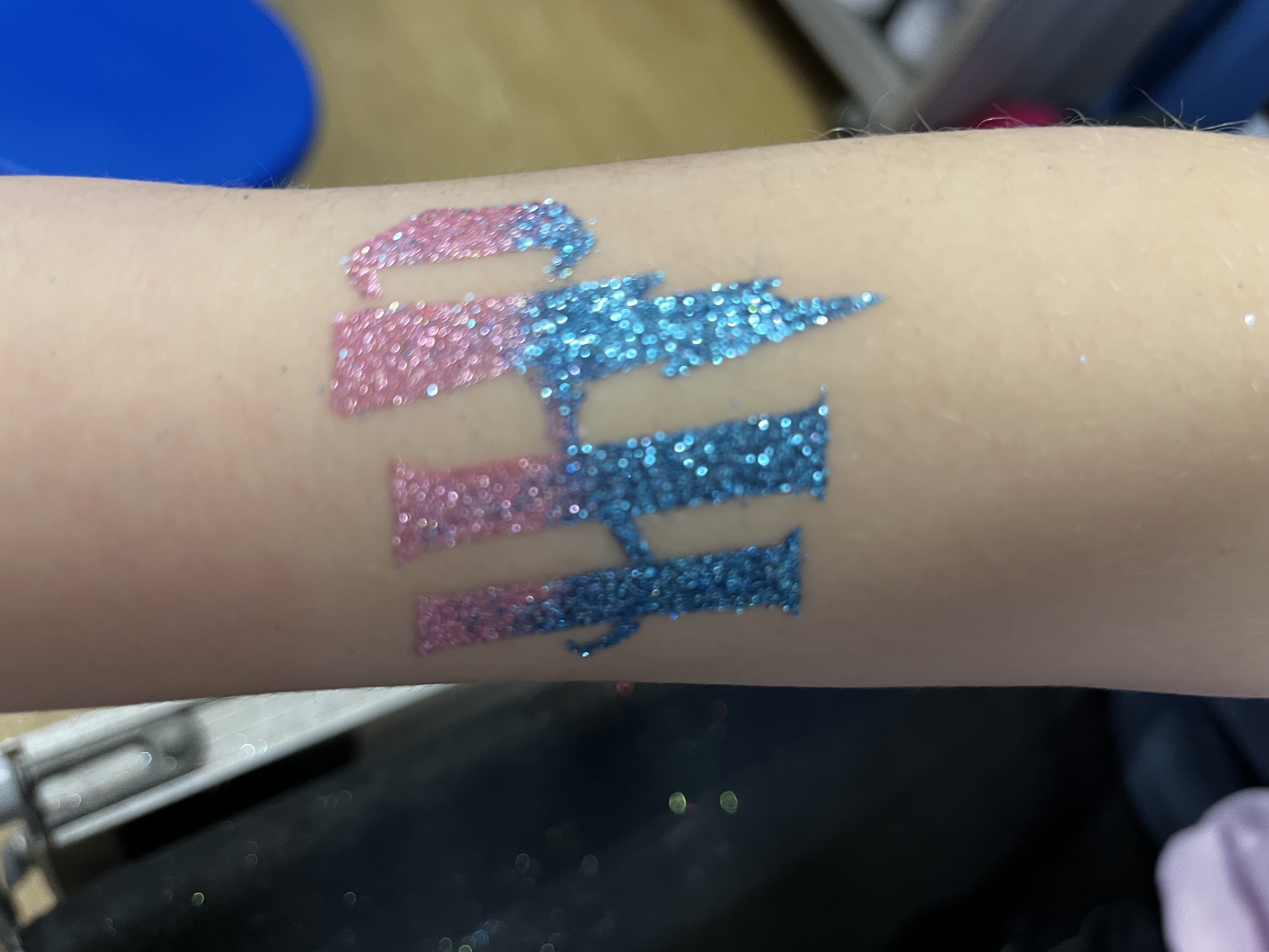 Harry Potter glitter tattoo on girls arm in telford
