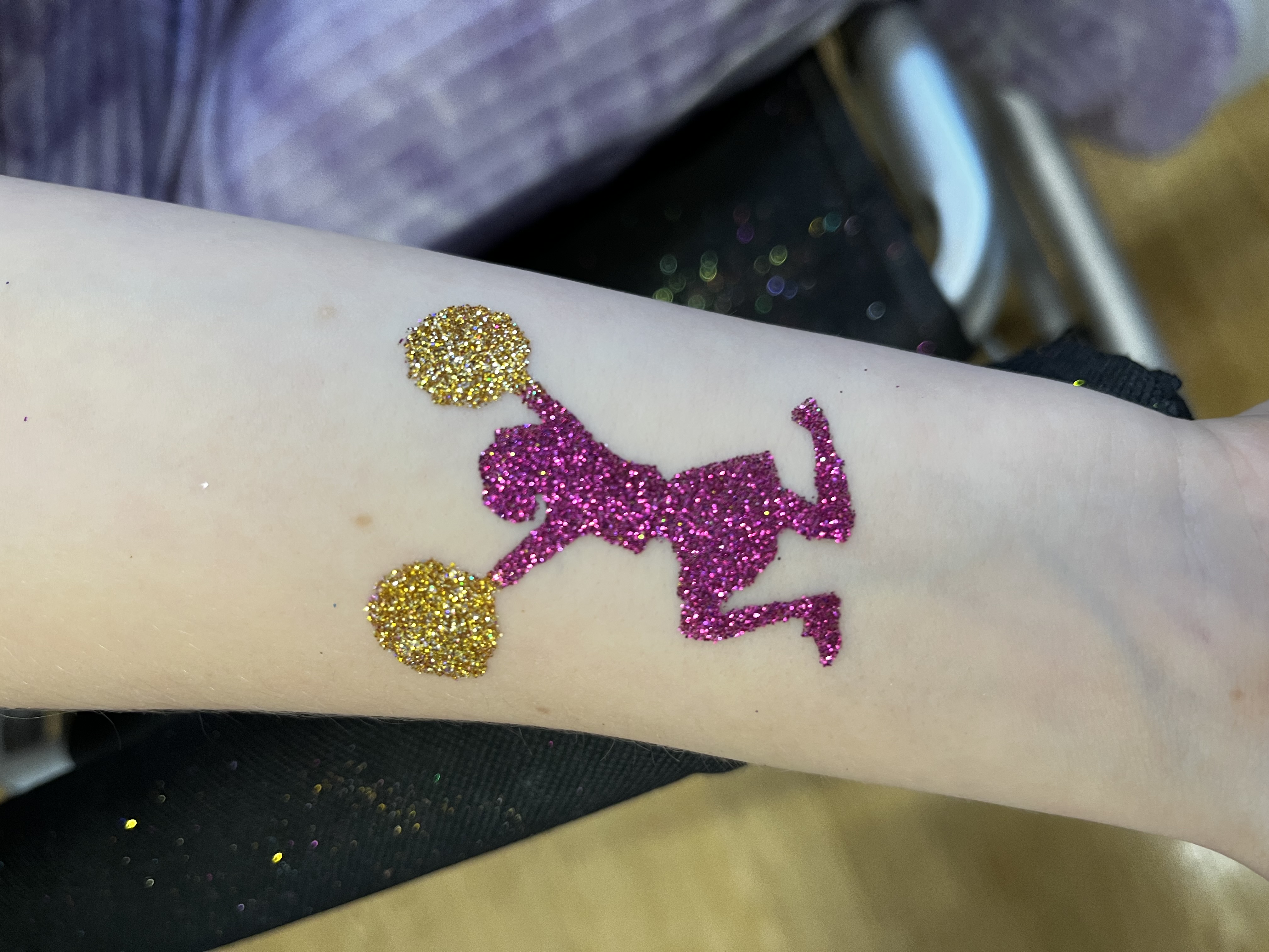 Cheerleader glitter tattoo on girls arm in telford at a party