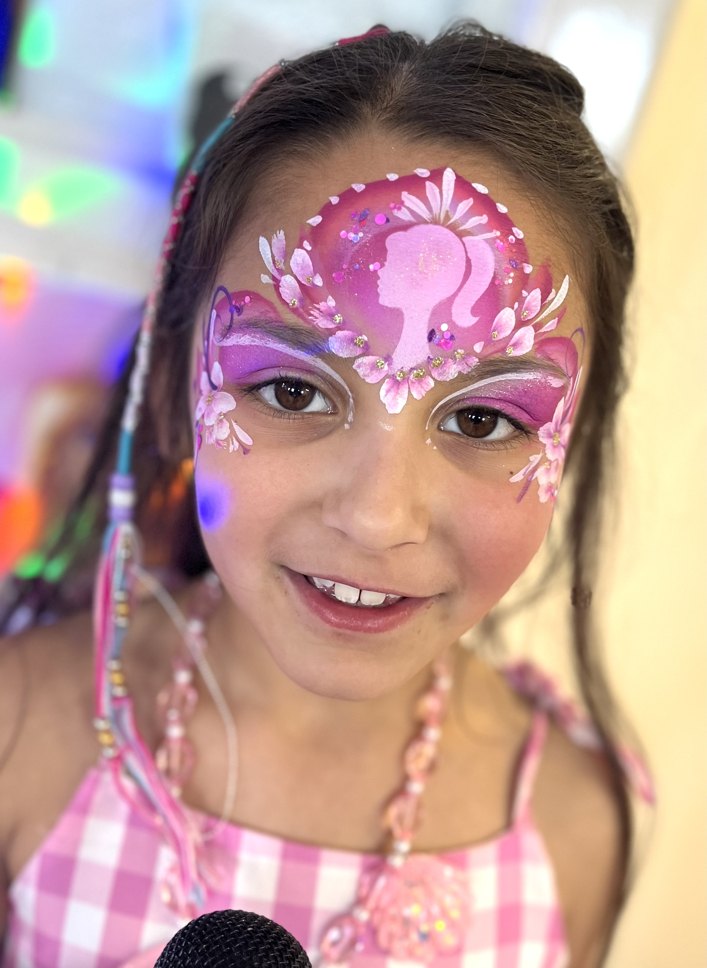 Pink Barbie face paint on young girl