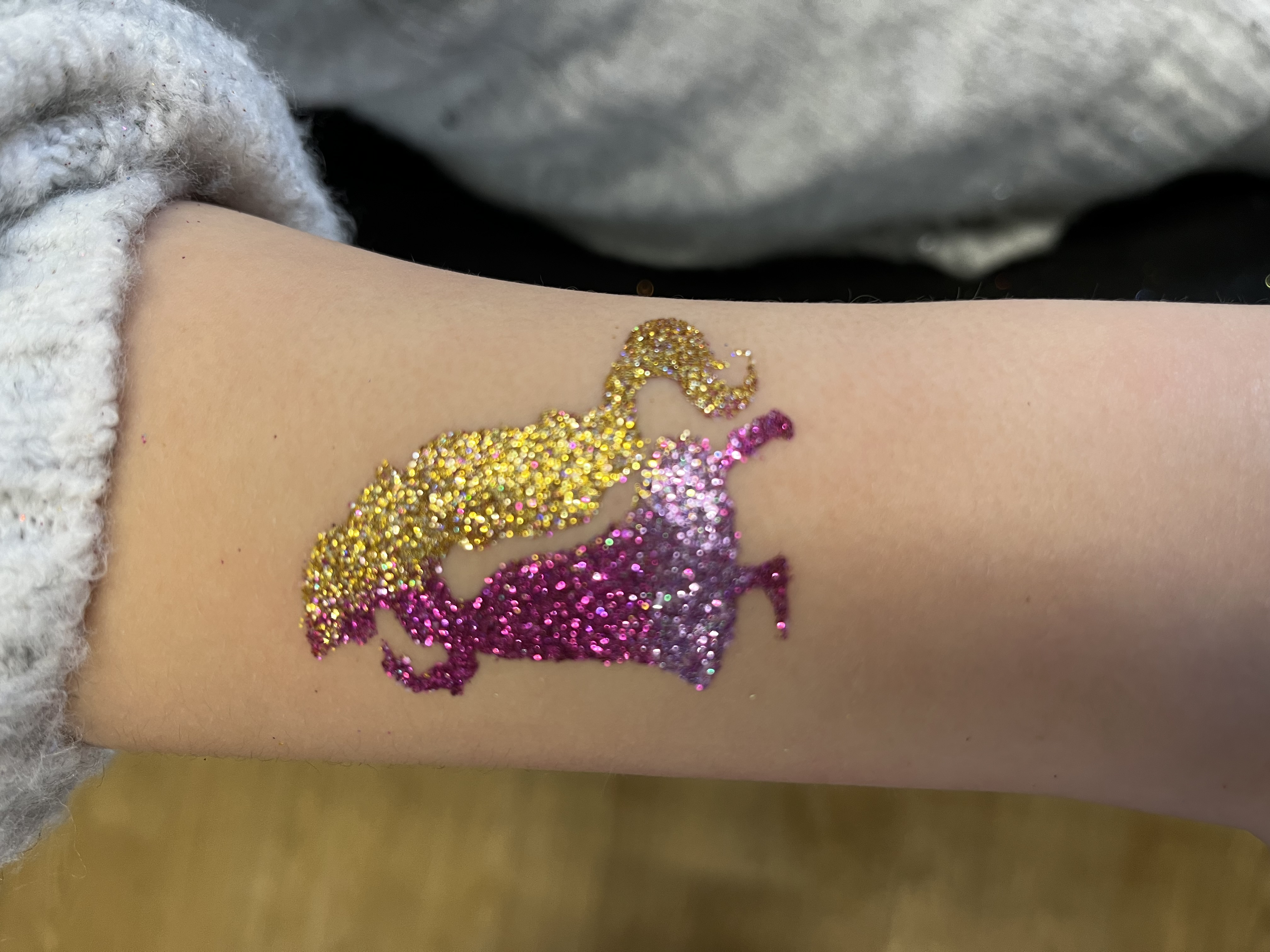 Rapunzel glitter tattoo on girls arm
