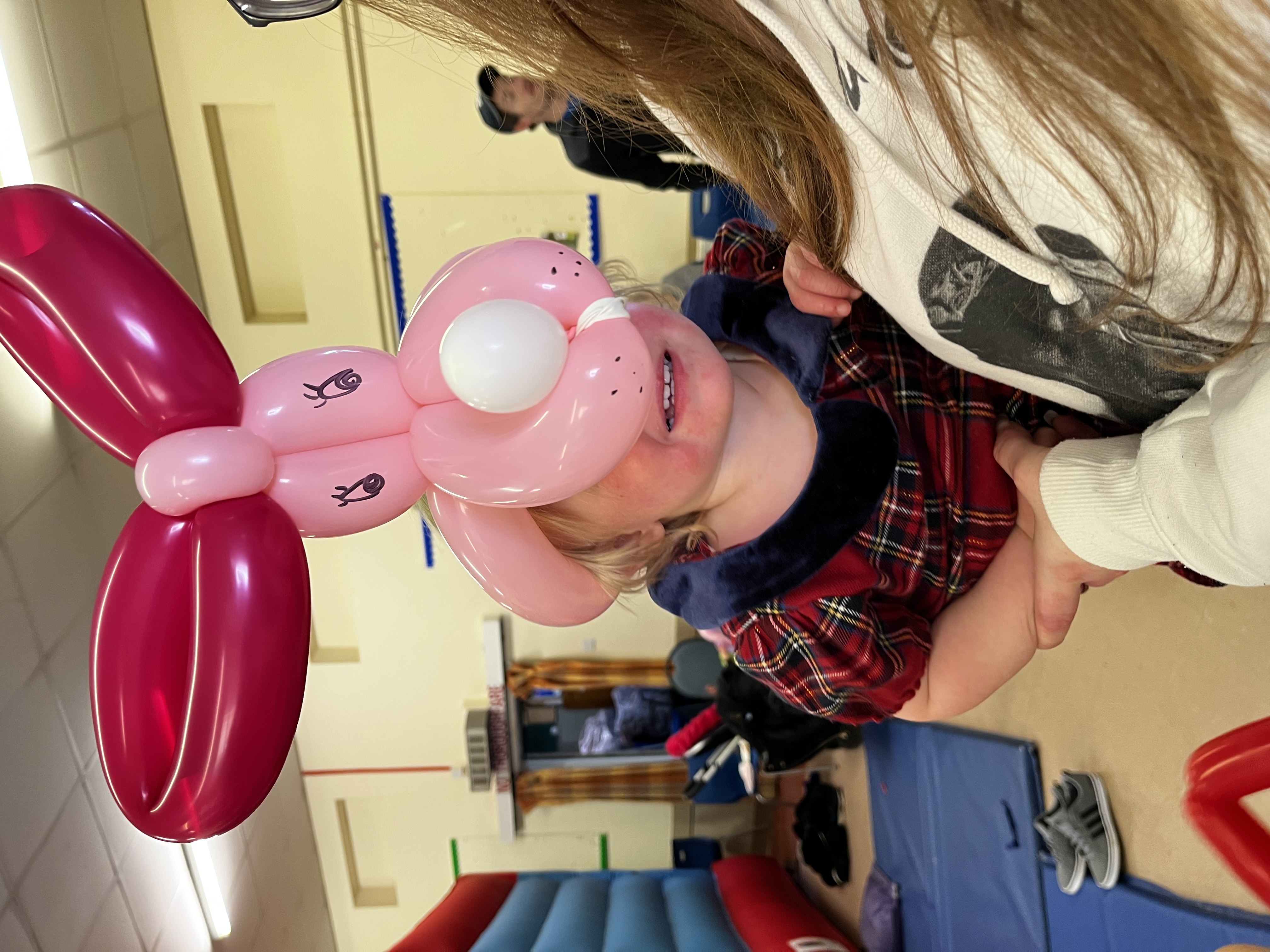 little girl wearing a dog balloon hat at a party in Shrewsbury