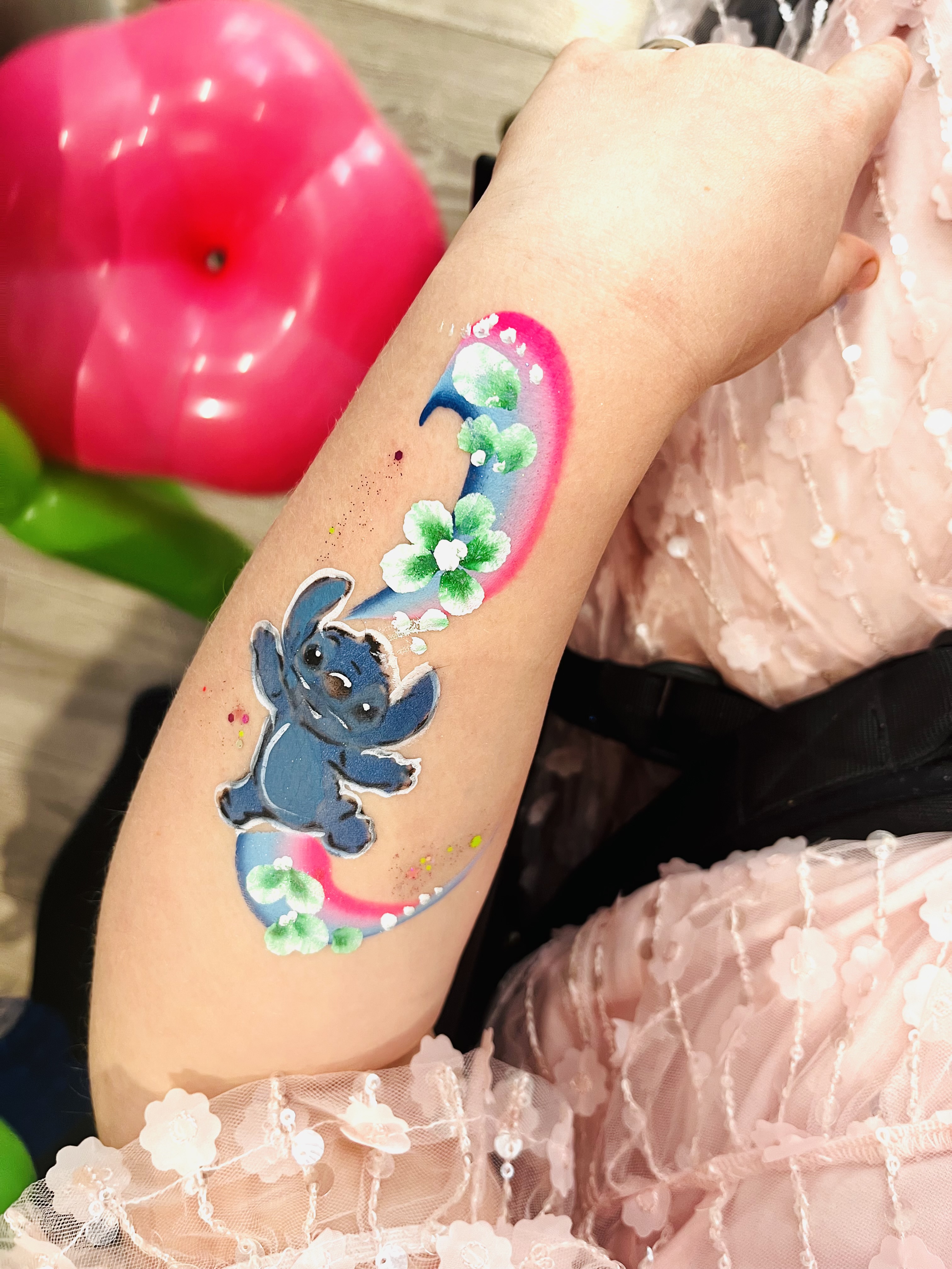 Stitch face paint in an arm at a party in Telford