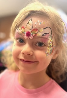 unicorn face paint on a young girl at a birthday party in Telford
