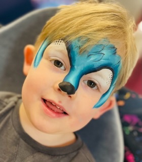 Sonic face paint on a boy at a party in Shifnal