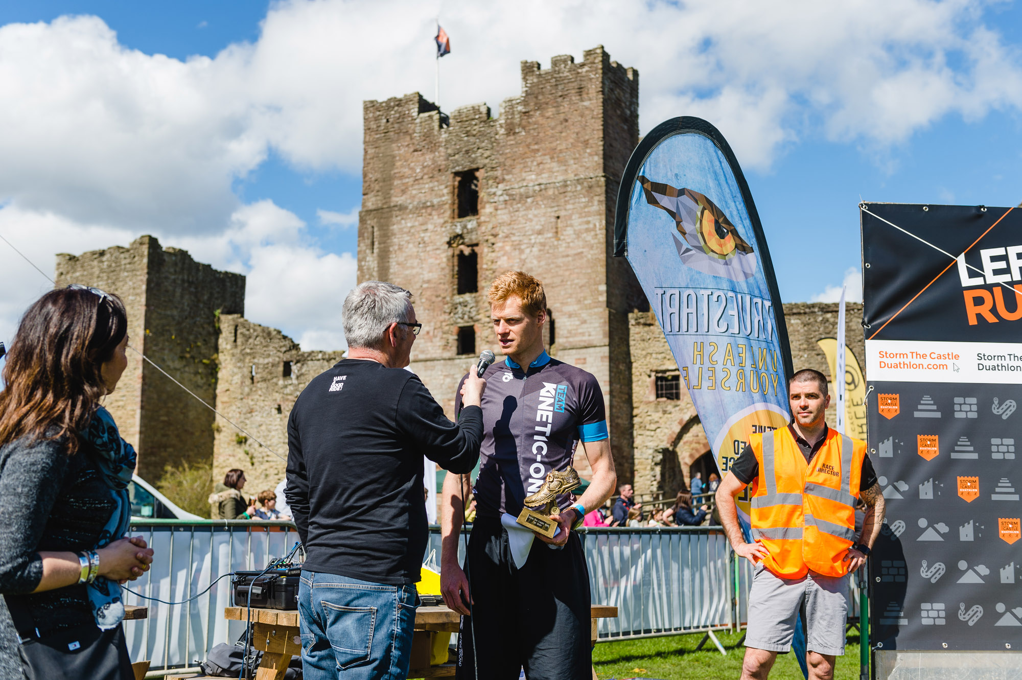 Duathlon runner being interviewed at Ludlow Castle after finishing Storm The Castle race